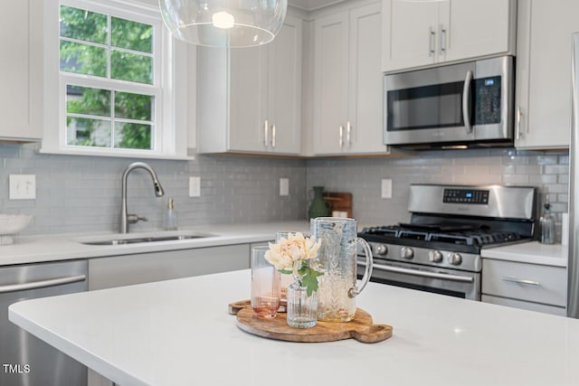 415 Dupree St, Durham, NC 27707 - kitchen featuring stainless steel appliances, a sink, light countertops, and backsplash