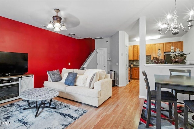 300 Gilman Ln Unit 101, Raleigh, NC 27610 - living room featuring light wood-style flooring, a chandelier, and ceiling fan