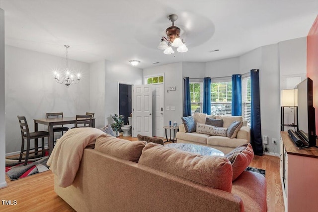 300 Gilman Ln Unit 101, Raleigh, NC 27610 - living area with light wood-style floors, a chandelier, ceiling fan, and baseboards