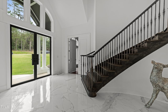 2220 Inwood Landing Ct, Raleigh, NC 27603 - entrance foyer featuring marble tiled flooring, a towering ceiling, stairway, french doors, and baseboards