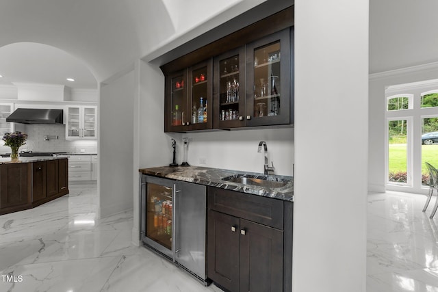2220 Inwood Landing Ct, Raleigh, NC 27603 - indoor wet bar with exhaust hood, beverage cooler, light marble finish flooring, crown molding, and tasteful backsplash