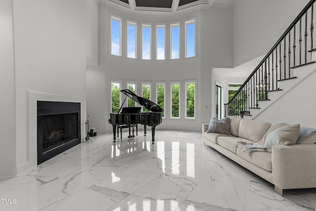 2220 Inwood Landing Ct, Raleigh, NC 27603 - living area with a towering ceiling, marble finish floors, stairs, a fireplace, and baseboards