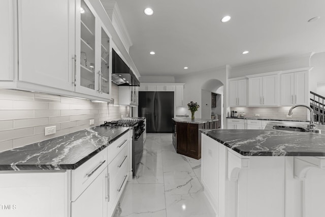 2220 Inwood Landing Ct, Raleigh, NC 27603 - kitchen with freestanding refrigerator, a sink, stainless steel gas range, wall chimney exhaust hood, and ornamental molding