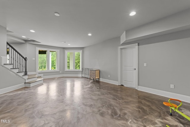 2220 Inwood Landing Ct, Raleigh, NC 27603 - unfurnished living room with finished concrete flooring, baseboards, recessed lighting, and stairway