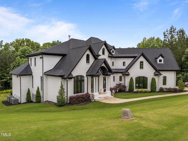 2220 Inwood Landing Ct, Raleigh, NC 27603 - french country home featuring a front yard, cooling unit, and roof with shingles