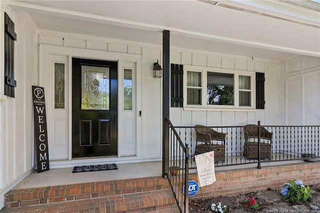 1926 Martindale Dr, Fayetteville, NC 28304 - view of exterior entry with board and batten siding and a porch