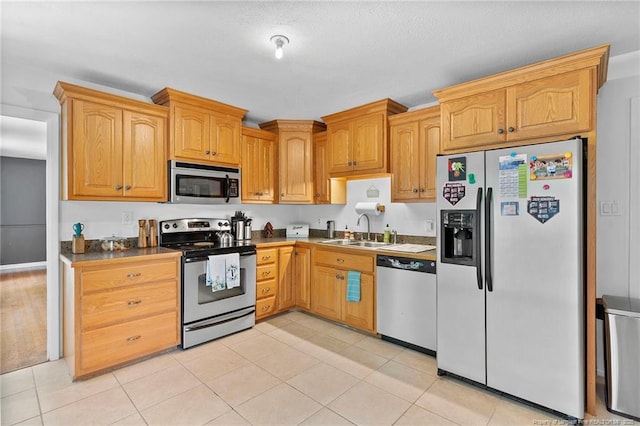 1926 Martindale Dr, Fayetteville, NC 28304 - kitchen featuring stainless steel appliances, a sink, and light tile patterned floors