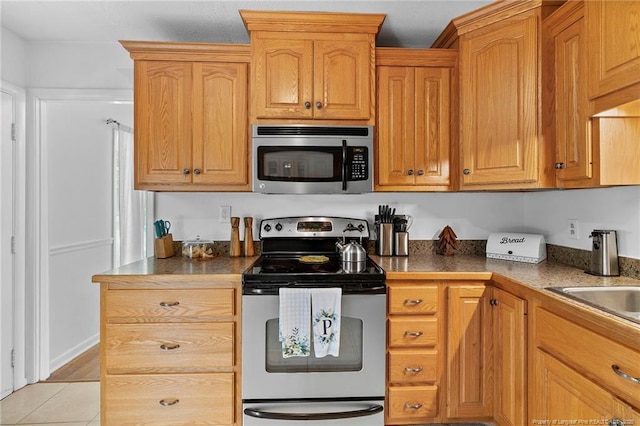 1926 Martindale Dr, Fayetteville, NC 28304 - kitchen featuring stainless steel appliances and light tile patterned flooring