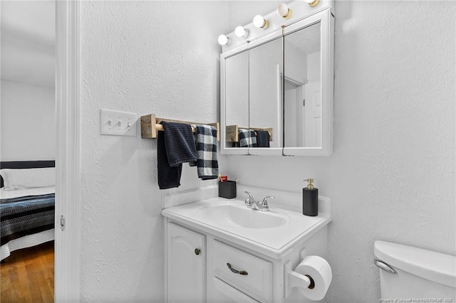 1926 Martindale Dr, Fayetteville, NC 28304 - half bathroom with vanity, a textured wall, toilet, and ensuite bath