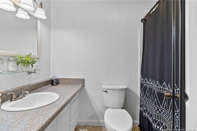1926 Martindale Dr, Fayetteville, NC 28304 - bathroom featuring vanity, toilet, baseboards, and a shower with shower curtain