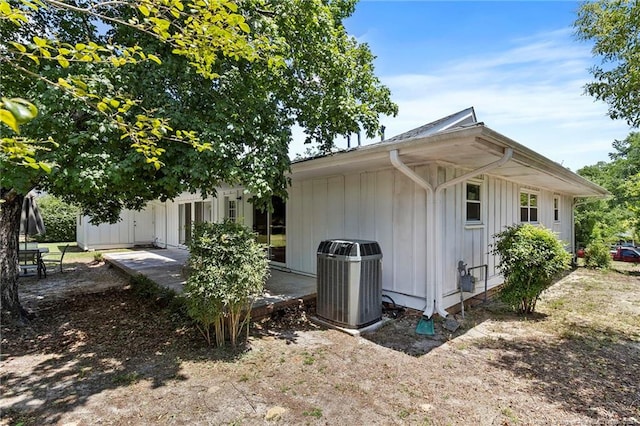 1926 Martindale Dr, Fayetteville, NC 28304 - view of side of home featuring cooling unit, board and batten siding, and a patio area