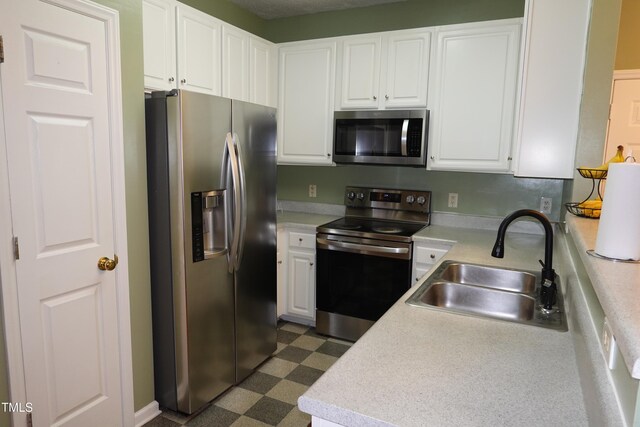 114 Calebra Way, Cary, NC 27519 - kitchen featuring appliances with stainless steel finishes, a sink, dark flooring, light countertops, and white cabinets