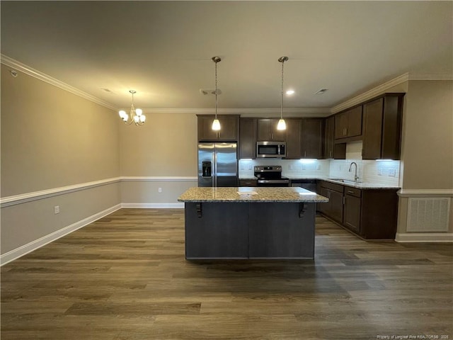 240 Gallery Dr Unit 301, Spring Lake, NC 28390 - kitchen with appliances with stainless steel finishes, a sink, a chandelier, dark brown cabinets, and ornamental molding