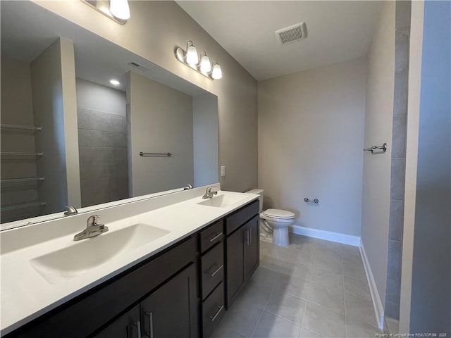 240 Gallery Dr Unit 301, Spring Lake, NC 28390 - bathroom featuring double vanity, tile patterned flooring, toilet, baseboards, and a tile shower