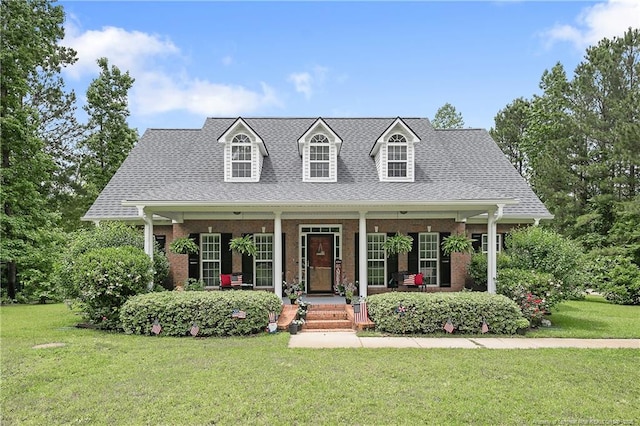 5387 Clubhouse Ln, Hope Mills, NC 28348 - cape cod home with a porch, a front yard, brick siding, and roof with shingles