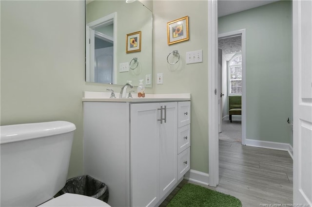 5387 Clubhouse Ln, Hope Mills, NC 28348 - bathroom featuring toilet, vanity, wood finished floors, and baseboards