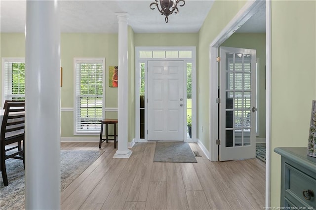 5387 Clubhouse Ln, Hope Mills, NC 28348 - foyer entrance with wood finished floors, ornate columns, and baseboards