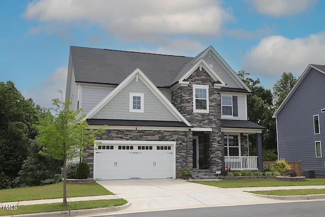 4416 Walker Hallow St, Raleigh, NC 27616 - craftsman house featuring stone siding, a porch, concrete driveway, and an attached garage