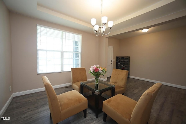 4416 Walker Hallow St, Raleigh, NC 27616 - dining area with a chandelier, a tray ceiling, and wood finished floors