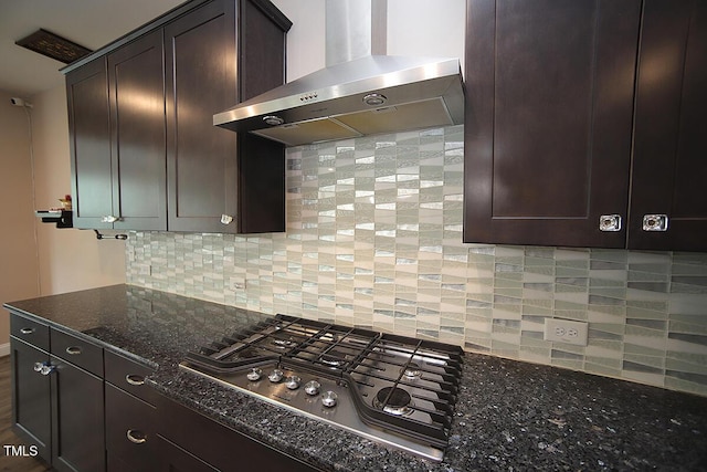 4416 Walker Hallow St, Raleigh, NC 27616 - kitchen featuring wall chimney range hood, stainless steel gas cooktop, dark stone countertops, decorative backsplash, and dark brown cabinetry