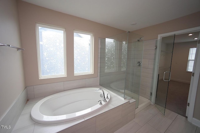 4416 Walker Hallow St, Raleigh, NC 27616 - full bathroom featuring healthy amount of natural light, a bath, a shower stall, and tile patterned floors
