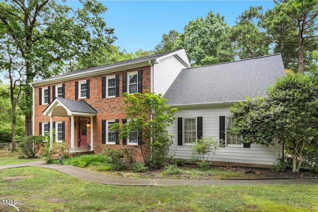 9509 Greenfield Dr, Raleigh, NC 27615 - colonial-style house with a front yard, brick siding, and a shingled roof