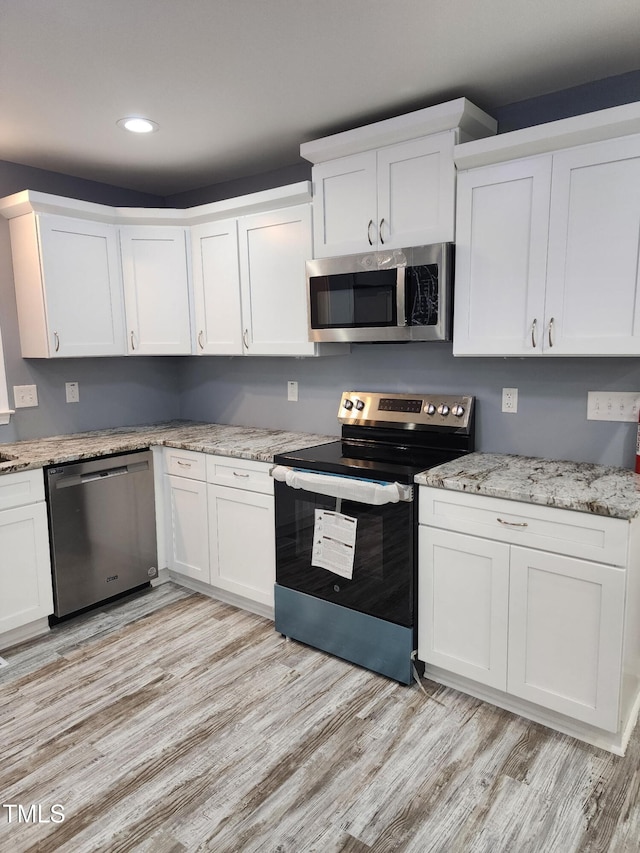 6905 Pine Creek Ct, Fayetteville, NC 28314 - kitchen featuring appliances with stainless steel finishes, light wood-type flooring, white cabinetry, and recessed lighting