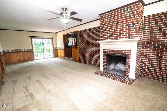 205 N Augusta Ave, Benson, NC 27504 - unfurnished living room featuring a ceiling fan, wainscoting, carpet flooring, crown molding, and a fireplace