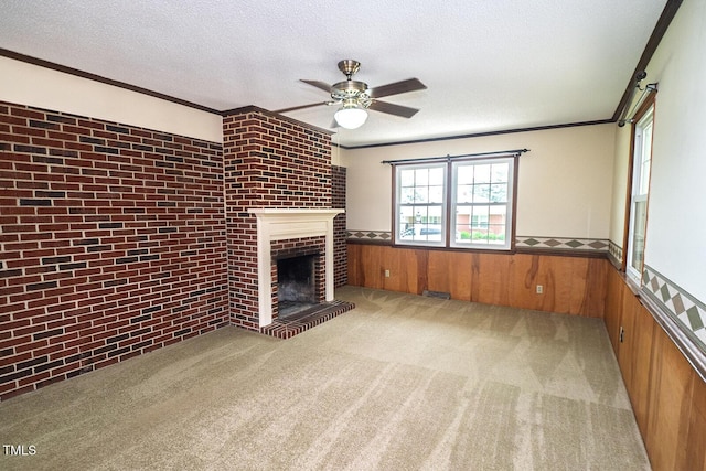 205 N Augusta Ave, Benson, NC 27504 - unfurnished living room with a wainscoted wall, a ceiling fan, a fireplace, carpet, and ornamental molding