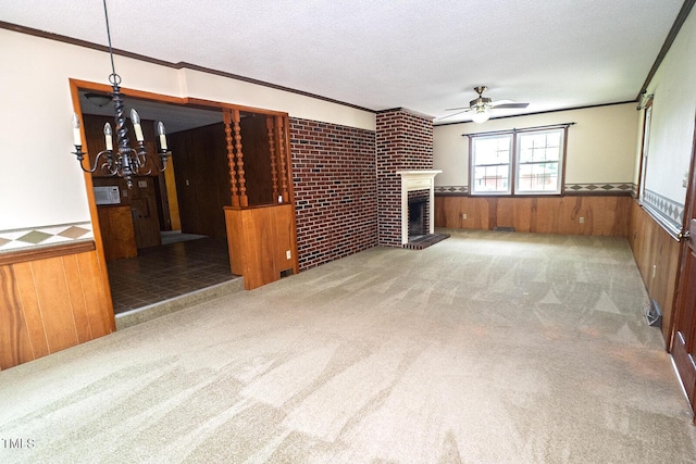 205 N Augusta Ave, Benson, NC 27504 - unfurnished living room featuring wainscoting, a chandelier, crown molding, wood walls, and carpet floors