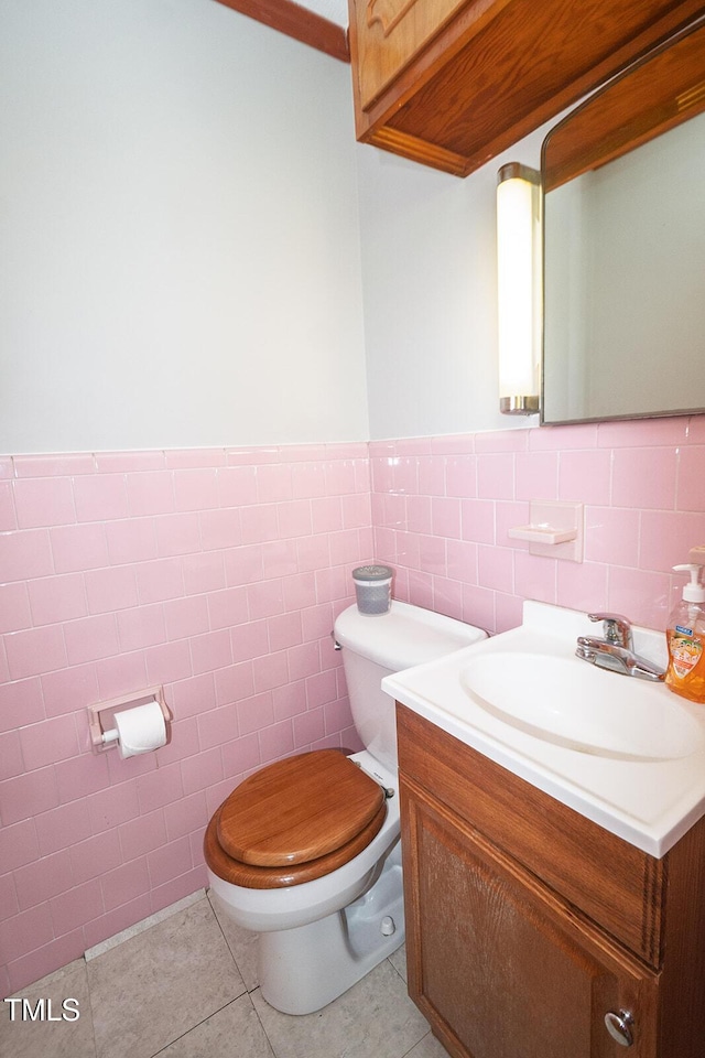 205 N Augusta Ave, Benson, NC 27504 - half bathroom featuring toilet, vanity, tile walls, tile patterned floors, and wainscoting