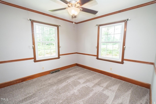 205 N Augusta Ave, Benson, NC 27504 - carpeted empty room featuring healthy amount of natural light, ornamental molding, baseboards, and a ceiling fan