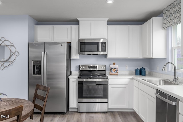 220 Gianna Dr, Lillington, NC 27546 - kitchen featuring appliances with stainless steel finishes, a sink, light countertops, white cabinetry, and recessed lighting
