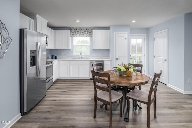 220 Gianna Dr, Lillington, NC 27546 - kitchen with appliances with stainless steel finishes, a sink, white cabinets, and recessed lighting