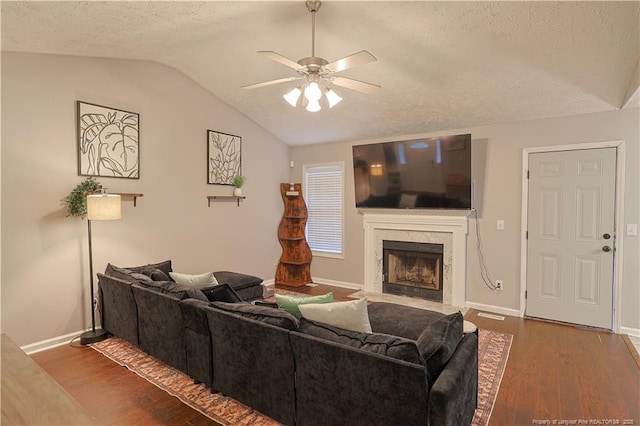 119 Proclamation Dr, Raeford, NC 28376 - living area with vaulted ceiling, ceiling fan, a premium fireplace, wood finished floors, and a textured ceiling