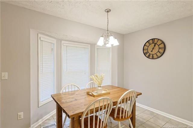 119 Proclamation Dr, Raeford, NC 28376 - dining space with light tile patterned floors, a chandelier, baseboards, and a textured ceiling