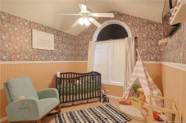 119 Proclamation Dr, Raeford, NC 28376 - bedroom featuring a wainscoted wall, wallpapered walls, a nursery area, lofted ceiling, and a textured ceiling