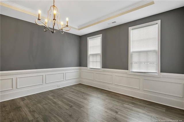 1664 Seattle Slew Ln, Hope Mills, NC 28348 - spare room with a chandelier, ornamental molding, a raised ceiling, wainscoting, and dark wood finished floors