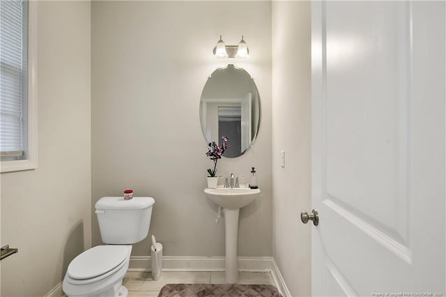 1664 Seattle Slew Ln, Hope Mills, NC 28348 - half bathroom with toilet, tile patterned floors, baseboards, and a sink