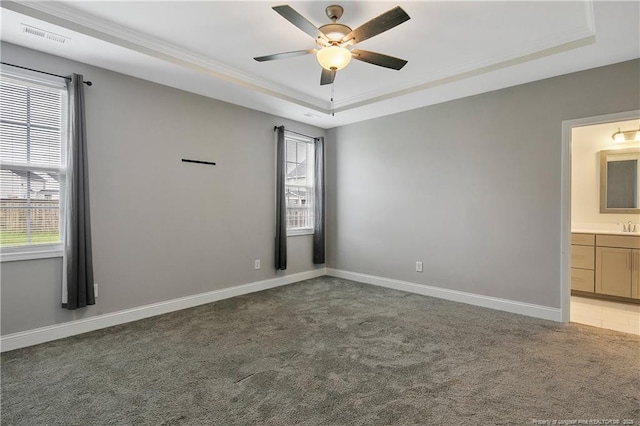 1664 Seattle Slew Ln, Hope Mills, NC 28348 - empty room featuring a tray ceiling, light colored carpet, ceiling fan, ornamental molding, and baseboards