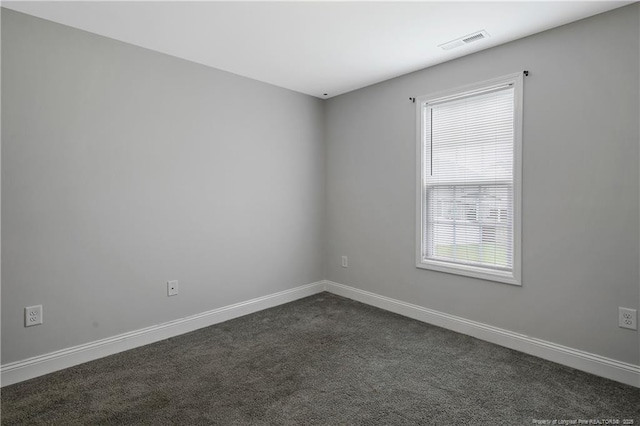 1664 Seattle Slew Ln, Hope Mills, NC 28348 - empty room featuring dark colored carpet and baseboards