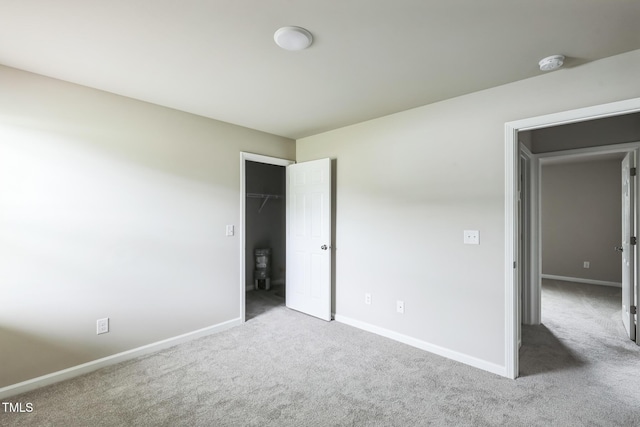 103 Hampshire Pl, Kenly, NC 27542 - unfurnished bedroom with carpet floors, baseboards, and a walk in closet