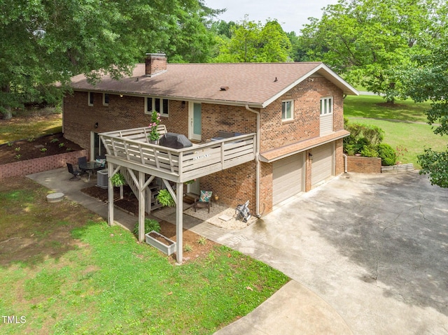 1822 Routh Rd, Burlington, NC 27217 - view of front of property with brick siding, a chimney, driveway, a garage, and a front lawn