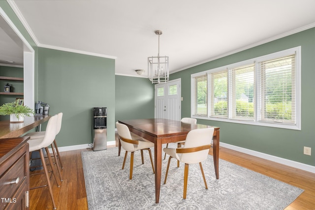 1822 Routh Rd, Burlington, NC 27217 - dining space with ornamental molding, wood finished floors, baseboards, and a chandelier