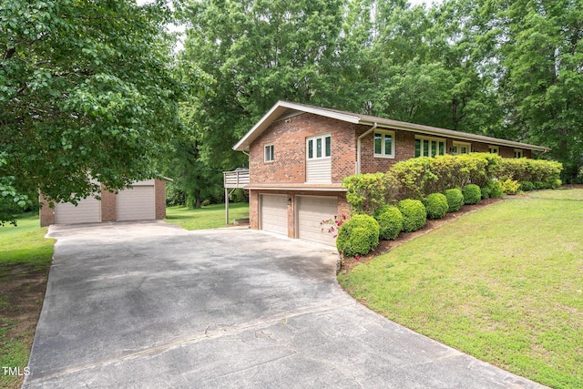 1822 Routh Rd, Burlington, NC 27217 - view of front of home featuring brick siding, a front lawn, an attached garage, driveway, and an outdoor structure