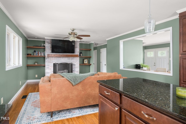 1822 Routh Rd, Burlington, NC 27217 - living area featuring healthy amount of natural light, ceiling fan, ornamental molding, and light wood finished floors