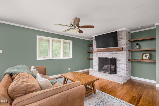 1822 Routh Rd, Burlington, NC 27217 - living room featuring crown molding, baseboards, wood finished floors, a brick fireplace, and ceiling fan