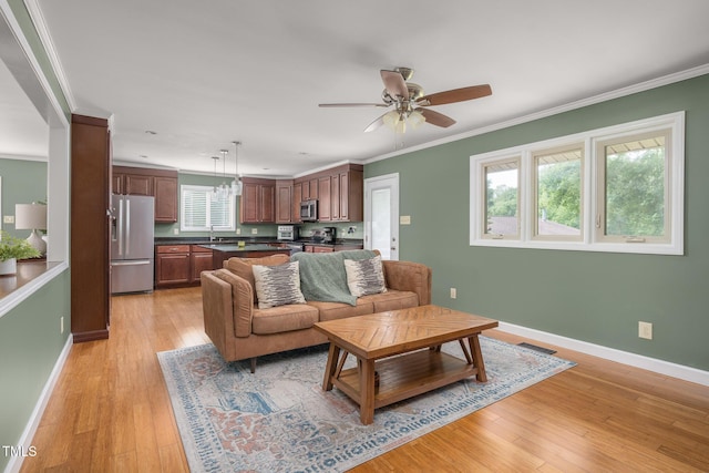 1822 Routh Rd, Burlington, NC 27217 - living room with light wood-style flooring, a ceiling fan, baseboards, and ornamental molding