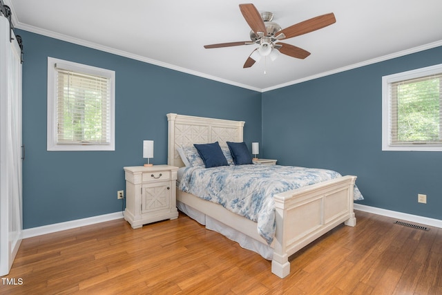 1822 Routh Rd, Burlington, NC 27217 - bedroom with multiple windows, baseboards, light wood-style flooring, and crown molding