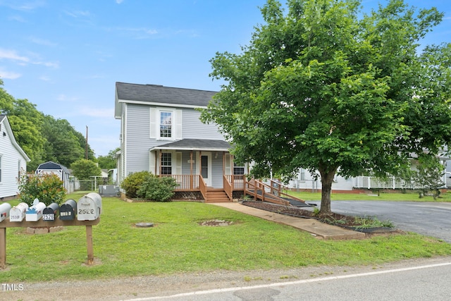 2527 Ossipee Front St, Elon, NC 27244 - view of front facade with covered porch, roof with shingles, and a front yard